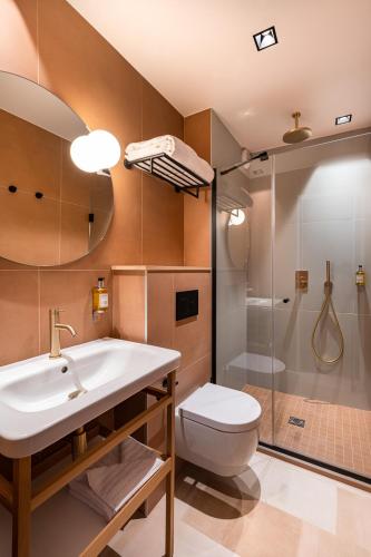 a bathroom with a sink and a toilet and a shower at O.Lysée Hotel in Paris