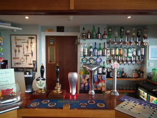 a bar with a lot of bottles on the wall at The Aqua in Shanklin