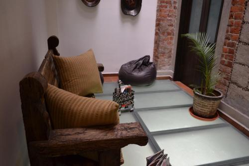 a porch with a chair and plants on a porch at Mexico City Hostel in Mexico City