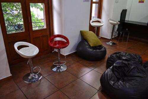 a room with chairs and bean bags on the floor at Mexico City Hostel in Mexico City