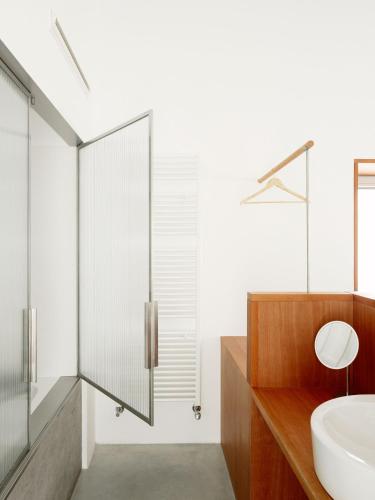 a bathroom with a glass shower and a sink at Hotel Bela Fisterra in Finisterre