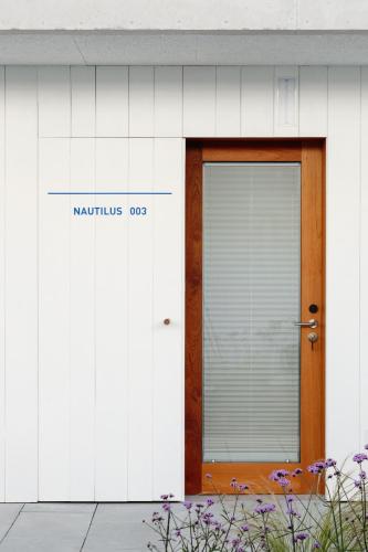 a door to a building with a sign on it at Hotel Bela Fisterra in Finisterre