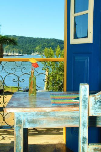 a table with a vase sitting on top of a balcony at Pousada do Cais in Paraty