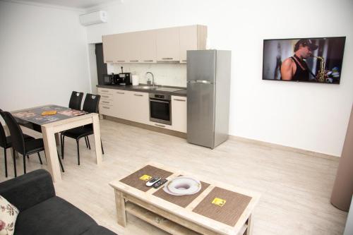 a small living room with a table and a kitchen at Central 10 in Oradea