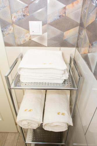 a shelf with towels on it in a refrigerator at Central 10 in Oradea