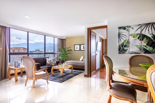 a living room with a couch and a table at Alcazar de Oviedo by EE Hoteles in Medellín