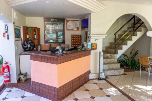 a restaurant with a bar in a building at Pousada Boulevard in Cabo Frio
