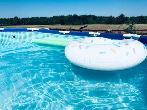 an inflatable raft in a swimming pool at Mazurski dom Brejdyny Sauna i Bania in Mrągowo