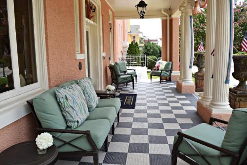a porch with couches and chairs on a house at JH Adams Inn, Trademark Collection by Wyndham in High Point
