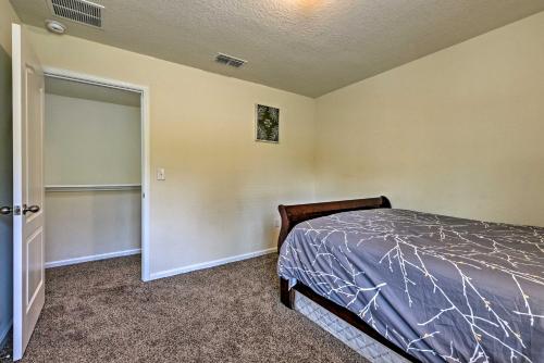 a bedroom with a bed and a door to a closet at Jax Home with Yard - 10 Mi to Adventure Landing! in Jacksonville
