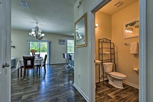 a living room with a toilet and a dining room at Jax Home with Yard - 10 Mi to Adventure Landing! in Jacksonville