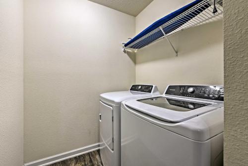 a small laundry room with a washer and dryer at Jax Home with Yard - 10 Mi to Adventure Landing! in Jacksonville