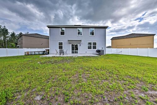 a large white house with a large yard at Jax Home with Yard - 10 Mi to Adventure Landing! in Jacksonville