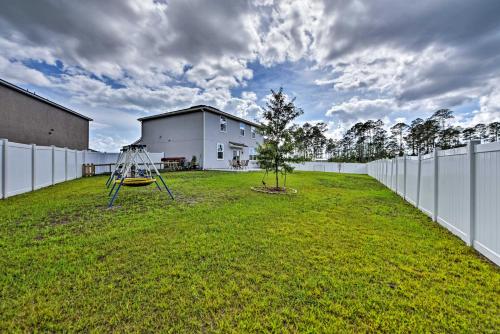 a yard with a tree and a swing at Jax Home with Yard - 10 Mi to Adventure Landing! in Jacksonville