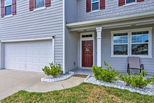 a house with a red door and a driveway at Jax Home with Yard - 10 Mi to Adventure Landing! in Jacksonville