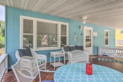 a room with chairs and a table on a porch at Steps to Lake of the Ozarks Family Home with Views! in Camdenton