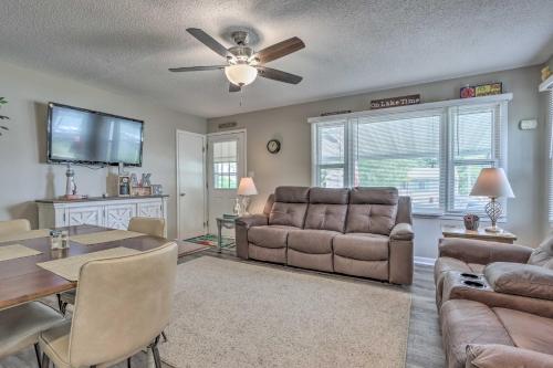 a living room with a couch and a dining room at Steps to Lake of the Ozarks Family Home with Views! in Camdenton