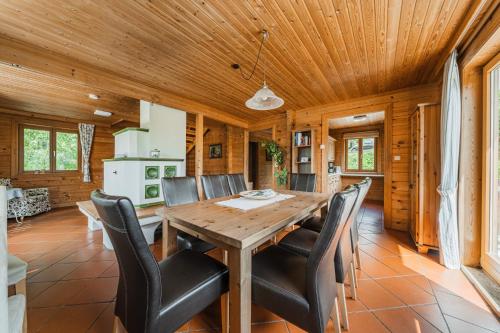 comedor con mesa de madera y sillas negras en Ferienhaus Panorama, en Bad Goisern