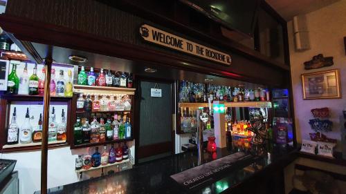 a bar with a lot of bottles of alcohol at Rock Dene Hotel in Blackpool