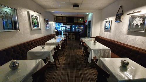 a dining room with tables and chairs in a restaurant at Rock Dene Hotel in Blackpool