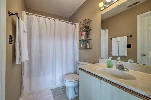 a bathroom with a sink and a toilet and a shower at Osage Beach Condo with Shared Pool and Lake Views! in Osage Beach