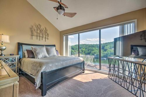 a bedroom with a bed and a large window at Osage Beach Condo with Shared Pool and Lake Views! in Osage Beach