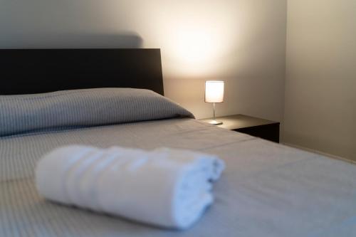 a white pillow sitting on top of a bed at Kalos Casa Vacanza in Salice Salentino