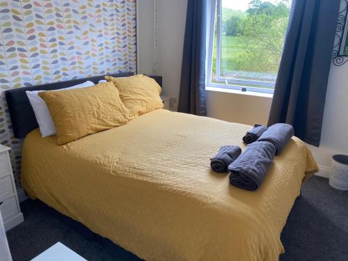 a bedroom with a bed with two blue towels on it at Wye View in Tintern