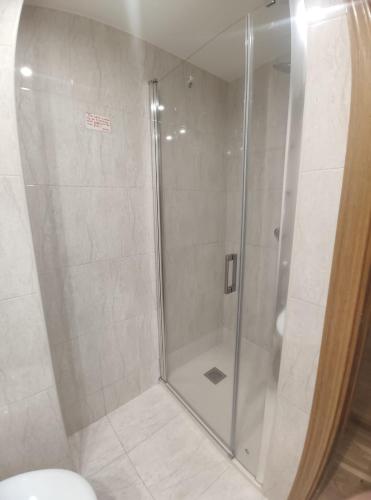 a shower with a glass door in a bathroom at Apartamento Libertad in Jaca
