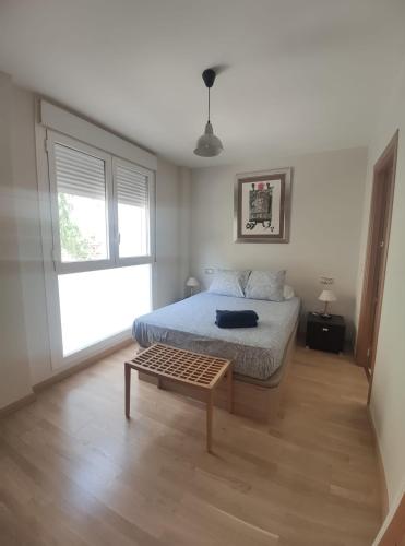 a bedroom with a bed and a table in it at Apartamento Libertad in Jaca