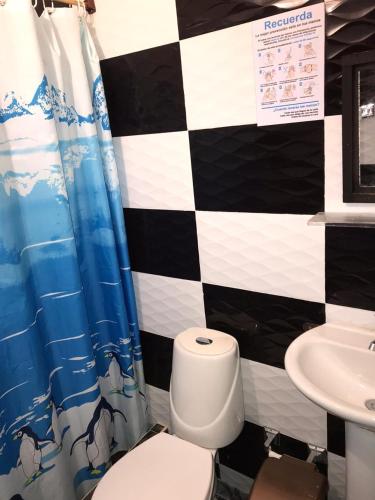 a bathroom with a toilet and a sink at Casa_22_Melgar in Melgar