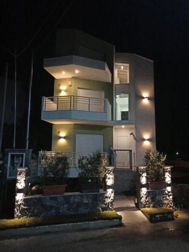 a large house with lights in front of it at night at Anastasia Mare Luxury in Stavros