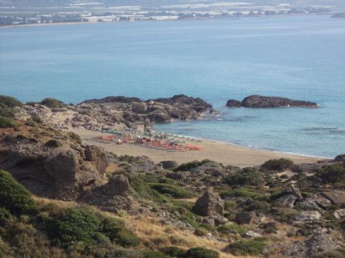 a beach with a bunch of people on it at Falasarna Bay in Falasarna