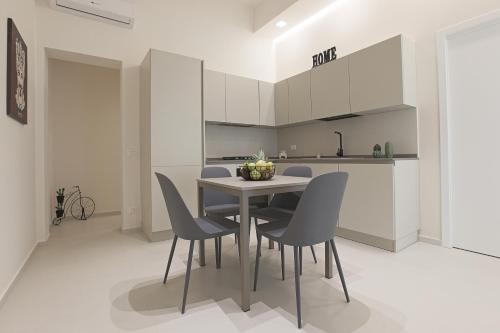 a kitchen with a table and chairs in a room at Casa Timone in San Leone