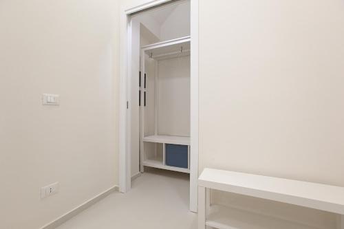 an empty closet with white walls and a mirror at Casa Timone in San Leone