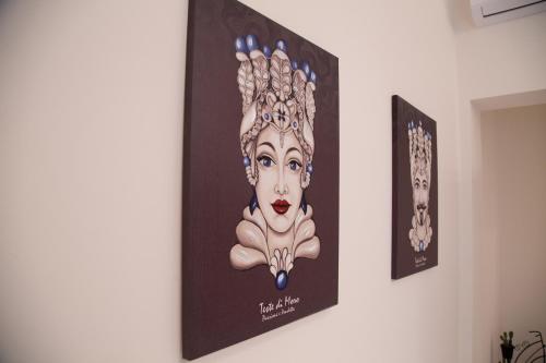 a picture of a woman on a wall at Casa Timone in San Leone