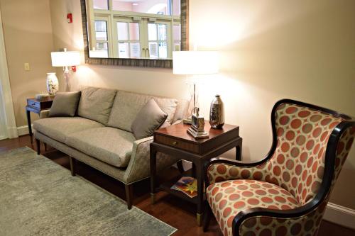 a living room with a couch and a table at JH Adams Inn, Trademark Collection by Wyndham in High Point