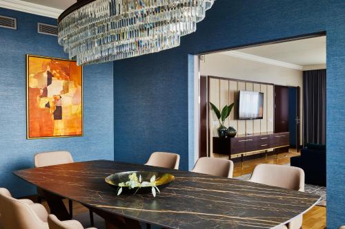 a dining room with a table and a chandelier at InterContinental Warszawa by IHG in Warsaw