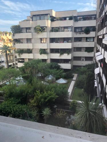 an apartment building with a garden in front of it at Studio Cannes Gray d'Albion in Cannes