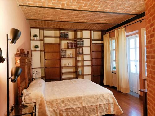 a bedroom with a bed and a large window at Agriturismo IL FRA' in Tigliole