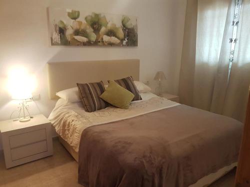 a bed with two pillows on it in a bedroom at Inviting 2-Bed Apartment 5 minutes to the beach in Punta Prima