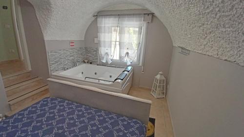 una vasca da bagno in una stanza con finestra di Casa Cristina - Vista Lago a Tignale
