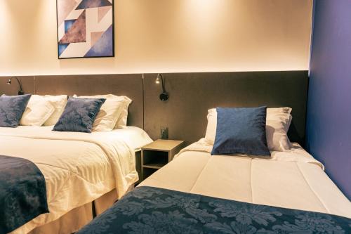 Cama ou camas em um quarto em Mayná Hotel Prudentópolis