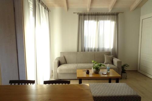 a living room with a couch and a table at Vasiliki Residence in Pylos