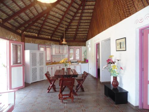 a kitchen with a table and chairs in a room at Las Puertas del Paraíso in Río San Juan