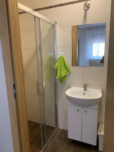 a bathroom with a sink and a shower at Willa RAJBI in Szczyrk