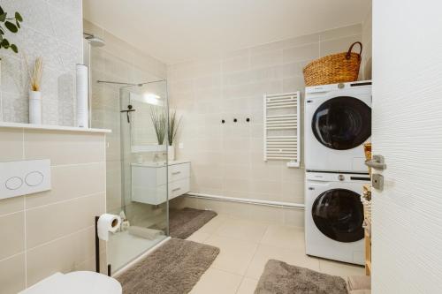 a laundry room with a washer and dryer at Monaco view, pool, garage, 100 m2 terrace in Beausoleil