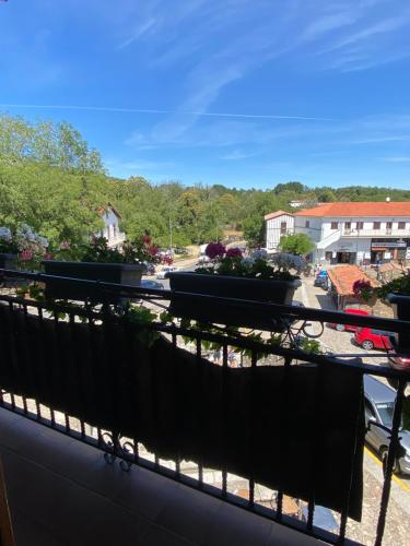 a balcony with a view of a parking lot at Hostal La Alberca in La Alberca