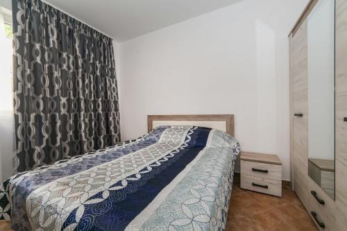a bedroom with a bed with a curtain and a dresser at Villa Angel in Kamenari