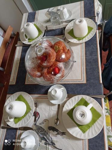 a table with plates of food on top of it at B&B Palazzo Bianchi in Parma